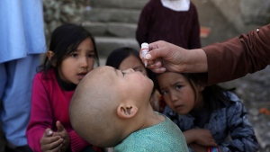 Shabana Maani, gives a polio vaccination to a child in the old part of Kabul, Afghanistan, Monday, March 29, 2021. (AP Photo/Rahmat Gul, File)
