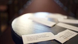 Cards printed in both Creole and English display a message of support for Haitians that reads, "I'm glad you are here. Christ loves you and so do I," near the altar at Central Christ Church after a service Sunday, Sept. 15, 2024, in Springfield, Ohio. (AP Photo/Luis Andres Henao)