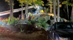 This Sunday, Sept. 15, 2024 photo provided by the Hillsborough Fire Department shows first responders at the scene of a rescue for a child who became wedged between two boulders, in Windsor, N.H. (Hillsborough Fire Department via AP)
