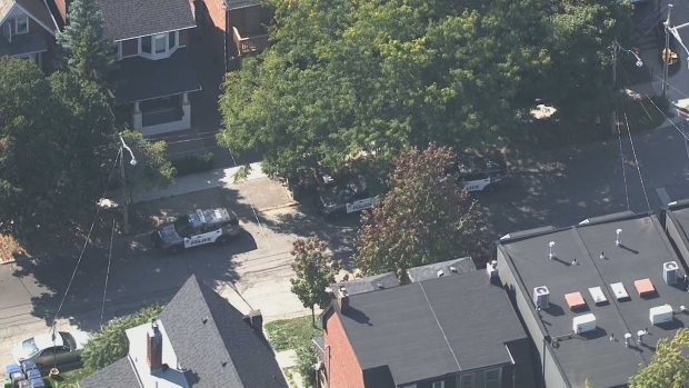 Police vehicles are shown near Spadina Road and Dupont Street after an officer was seriously injured responding to a call for a person in crisis.