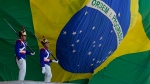 Presidential guards march by a large Brazilian flag at Planalto presidential palace in Brasilia, Brazil, Monday, Oct. 17, 2022. (AP Photo / Eraldo Peres)