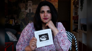 Sanniah Jabeen poses for a photograph holding a print of an ultrasound of her unborn baby boy Waleed who died after Sanniah contracted listeria, in Toronto, on Thursday, Sept. 5, 2024. THE CANADIAN PRESS/Arlyn McAdorey