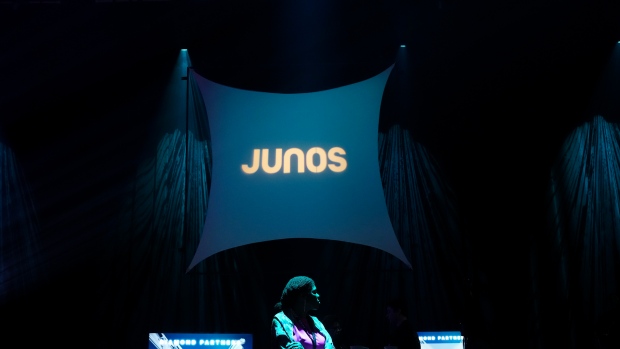 A woman awaits for the Juno Awards nominees announcement to start in Toronto on Tuesday, February 6, 2024. THE CANADIAN PRESS/Nathan Denette