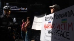 Protesters gather outside the TIFF Lightbox before a screening of the documentary film "Russians At War" in Toronto, Tuesday, Sept. 17, 2024. THE CANADIAN PRESS/Chris Young