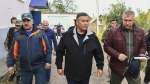 Tver region governor Igor Rudenya, centre, arrives in Toropets, following the strike by unmanned aerial vehicles in Toropets, Russia on Wednesday, Sept. 18, 2024. (Press Service of the Government of the Tver Region of Russia via AP)