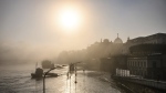 A view of the Terrassenufer in the Old Town is flooded by the high water of the Elbe in the morning fog, in Dresden, Germany, Wednesday, Sept. 18, 2024. (Robert Michael/dpa via AP)