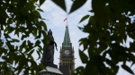 The Liberal government says it is further cutting the number of permits it issues to international students who come to Canada to study. The Peace Tower on Parliament Hill is framed by leaves in Ottawa on Tuesday, Aug. 27, 2024. THE CANADIAN PRESS/Sean Kilpatrick