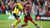 Toronto FC forward Lorenzo Insigne (24) is defended by Columbus Crew defender Andres Herrera, during first half MLS soccer action, in Toronto on Wednesday, September 18, 2024. THE CANADIAN PRESS/Chris Katsarov