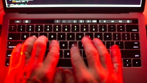 A man uses a computer keyboard in Toronto in this Oct. 9, 2023 photo illustration. (Graeme Roy / The Canadian Press)