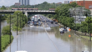 Cars are partially submerged in flood waters in the Don Valley following heavy rain in Toronto, on July 16 2024. THE CANADIAN PRESS/Arlyn McAdorey