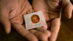 Robert Calabretta holds his baby photo from before he was adopted out of South Korea to a family in the United States at his apartment in New York on Feb. 15, 2024. (David Goldman / AP Photo)
