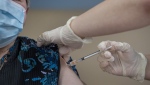 Amanda Parsons, a registered nurse on staff at the Northwood Care facility, administers a dose of the Moderna vaccine to Ann Hicks, 77, in Halifax on Monday, Jan. 11, 2021. Health Canada has authorized Novavax's updated COVID-19 vaccine. THE CANADIAN PRESS/Andrew Vaughan-Pool