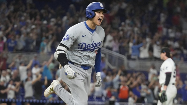 Los Angeles Dodgers' Shohei Ohtani (17) reacts after hitting his 50th home run of the season during the seventh inning of a baseball game against the Miami Marlins, Thursday, Sept. 19, 2024, in Miami. (AP Photo/Marta Lavandier)