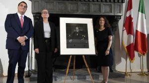 From left, Nicola Cassinelli, an Italian lawyer and occasional art collector, Canadian Cultural Heritage Deputy Minister, Isabelle Mondou and Ambassador of Canada to Italy, Elissa Golberg, pose next to of a photographic portrait known as 'The Roaring Lion', taken by photographer Yousuf Karsh in 1941 of Britain's Prime Minister Winston Churchill, stolen in Canada in 2022 and returned during a ceremony at the Canada's embassy in Rome, Thursday, Sept. 19, 2024. (AP Photo/Alessandra Tarantino)