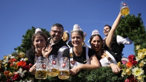 The Oktoberfest hosts arrive for the start of the 189th 'Oktoberfest' beer festival in Munich, Germany, Saturday, Sept. 21, 2024. (AP Photo/Matthias Schrader)