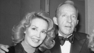 Bing Crosby stands with his wife, Kathryn, left in New York on Dec. 8, 1976. (AP Photo/Carlos Rene Perez, File)