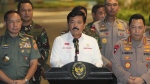 Indonesian Coordinating Minister for Political, Legal, and Security Affairs Hadi Tjahjanto, centre, speaks to the media after the arrival of Phillip Mark Mehrtens, a New Zealand pilot who was held hostage by separatist rebels, at Halim Perdanakusuma Air Base in Jakarta, Indonesia, Saturday, Sept. 21, 2024. (AP Photo/Achmad Ibrahim)