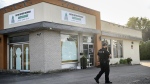 A Police officer outside the Centre Culturel Musulman in Chateauguay, Que., Friday September 20, 2024. Three men have been injured after a 24-year-old man entered a mosque southwest of Montreal armed with a knife. THE CANADIAN PRESS/Graham Hughes