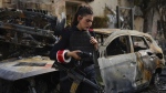 An Israeli police officer examines the site hit by a rocket fired from Lebanon, in Kiryat Bialik, northern Israel, on Sunday, Sept. 22, 2024. (AP Photo//Ariel Schalit)