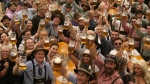 Festival enjoy the first glasses of beer on day one of the 189th 'Oktoberfest' beer festival in Munich, Germany, Saturday, Sept. 21, 2024. (AP Photo/Matthias Schrader)