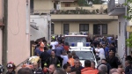 Emergency services attend the site of a building collapse in Saviano, Italy, Sunday Sept, 22, 2024. (LaPresse via AP)