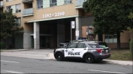 Police are pictured outside a complex at Kingston and Markham roads where one person was fatally shot. 