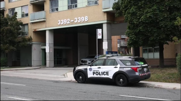 Police are pictured outside a complex at Kingston and Markham roads where one person was fatally shot. 