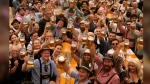 Festival enjoy the first glasses of beer on day one of the 189th 'Oktoberfest' beer festival in Munich, Germany, Saturday, Sept. 21, 2024. (AP Photo/Matthias Schrader)