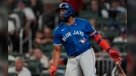 Toronto Blue Jays first base Vladimir Guerrero Jr. (27) hits a single in the sixth inning of a baseball game against the Atlanta Braves Friday, Sept. 6, 2024, in Atlanta. (AP Photo/John Bazemore)