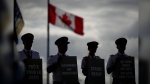 Air Canada pilots air silhouetted while holding signs during an informational picket at Vancouver International Airport in Richmond, B.C., on Tuesday, August 27, 2024. The union head for Air Canada pilots says she'll step down if members opt not to approve a tentative deal with the company. THE CANADIAN PRESS/Darryl Dyck