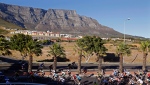 Cyclists pass on a major road with a backdrop of Table Mountain as they leave the city of Cape Town, South Africa, Sunday, March 8, 2015. (AP Photo/Schalk van Zuydam)