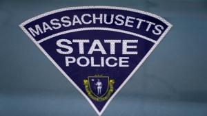 The seal of the Commonwealth of Massachusetts is displayed on a Massachusetts State Police cruiser parked outside the Statehouse, March 3, 2023, in Boston. (AP Photo/Charles Krupa, File)
