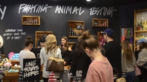 Cosmetics brand Lush says it is laying off staff as it scales down operations at its Vancouver facilities. Holiday shoppers check on discounts at a Lush cosmetics store in Denver, Colo. on Friday, Nov. 24, 2017. THE CANADIAN PRESS/AP/ Tatiana Flowers
