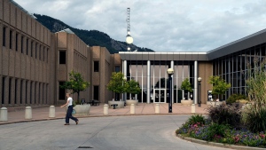 A woman walks in front of the Boulder County Justice Center in Boulder, Colo., Sept. 5, 2024. (AP Photo/Thomas Peipert)