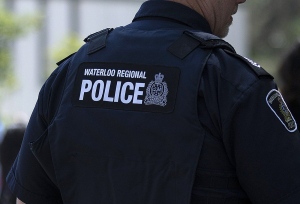 Police in Waterloo Region say they are investigating a crash that killed three people and injured three others. A police officer looks on during an event in Waterloo, Ont., Thursday, June 29, 2023. (THE CANADIAN PRESS/Nicole Osborne)