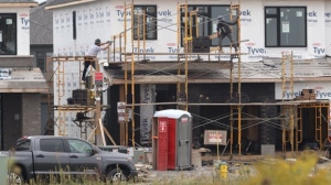 People work on new residential construction in the Riverside South neighbourhood of Ottawa, Friday, Aug. 30, 2024. THE CANADIAN PRESS/ Patrick Doyle