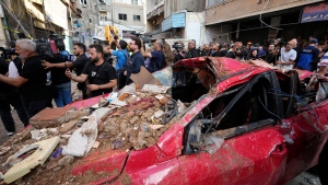 Journalists gather at the scene of a building that was hit by an Israeli airstrike in Beirut's southern suburbs, Tuesday, Sept. 24, 2024. (Hassan Ammar / AP Photo)