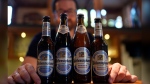 Head Brewmaster Tobias Zollo poses behind non alcoholic beer at the Weihenstephan brewery in Freising, Germany, Friday, Sept. 20, 2024. (AP Photo/Matthias Schrader)