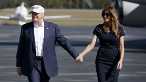 Republican presidential candidate Donald Trump, left, and his wife Melania arrive to a campaign rally, Nov. 5, 2016, in Wilmington, N.C. (AP Photo/ Evan Vucci, File)