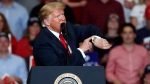 Former U.S. President Donald Trump looks at his watch near the end of a campaign rally Monday, Nov. 5, 2018, in Cape Girardeau, Mo. (Jeff Roberson / AP Photo)