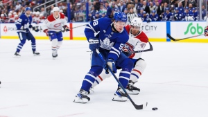 Montreal Canadiens' Jayden Struble (47) checks Toronto Maple Leafs' Easton Cowan (53) during second period pre-season NHL hockey action in Toronto on Thursday, September 26, 2024. THE CANADIAN PRESS/Cole Burston