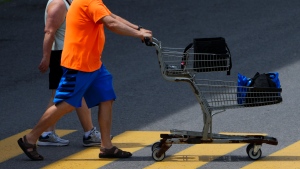 Statistics Canada will release its May gross domestic product report this morning. A shopper pushes a shopping carts as they leave a Real Canadian Superstore in Ottawa on Tuesday, June 25, 2024. THE CANADIAN PRESS/Sean Kilpatrick