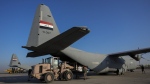 Iraqi security forces prepare for loading humanitarian aid from Red Crescent for Palestinians in Gaza, before its departure from a military airbase near Baghdad International Airport in Baghdad, Iraq, Jan. 24, 2024. (AP Photo/Hadi Mizban)