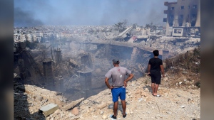 People check a damaged building at the site of an Israeli airstrike in Choueifat, south east of Beirut, Saturday, Sept. 28, 2024. Canada is contributing $10 million for humanitarian assistance for civilians in Lebanon amid the escalating conflict between Israel and Hezbollah. THE CANADIAN PRESS/AP, Hussein Malla