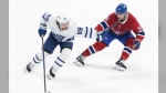 Toronto Maple Leafs' Nicholas Robertson (89) protects the puck against Montreal Canadiens' Toronto Maple Leafs' Nicholas Robertson (15) during first period NHL pre-season action in Montreal on Saturday, Sept. 28, 2024. THE CANADIAN PRESS/Evan Buhler