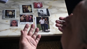 Suzy Patton shows old photos of her brother Steve Szarewicz, who insists he was wrongly convicted of a 1981 murder based on the testimony of four jailhouse informants on Tuesday, April 30, 2024 in her home in New Kensington, Pa. (AP Photo/Gene J. Puskar)