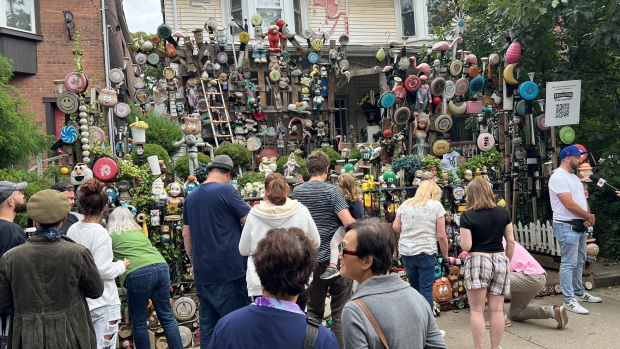 People line up outside the 'Leslieville dollhouse' on Sunday Sept. 29, 2024 to collect a piece of Toronto history.