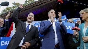 Michael Schnedlitz, right, and Christian Hafenecker of the Freedom Party of Austria cheer at the party headquarters in Vienna, Austria, Sunday, Sept. 29, 2024 upon seeing initial electoral projections. (AP Photo/Heinz-Peter Bader)