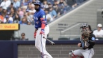 Toronto Blue Jays designated hitter Vladimir Guerrero Jr. tosses his bat after being walked by Miami Marlins pitcher Ryan Weathers as catcher Nick Fortes during first inning interleague MLB baseball action in Toronto, Sunday, Sept. 29, 2024. THE CANADIAN PRESS/Chris Young