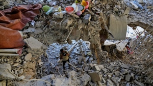 A photographer documents damage in a building that was hit by an Israeli airstrike in Beirut's southern suburb, Lebanon, Monday, Sept. 30, 2024. (AP Photo/Hassan Ammar)